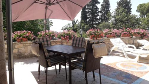 a table and chairs with an umbrella on a patio at Appartment Plaza in Krnica