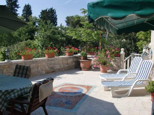 a patio with a table and chairs and a fire pit at Appartment Plaza in Krnica