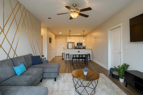a living room with a couch and a table at Across from UAB Spacious 2BR Retreat 5th in Homewood