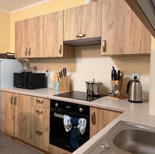 a kitchen with a stove top oven next to a sink at Zacisze Nad Stawami 
