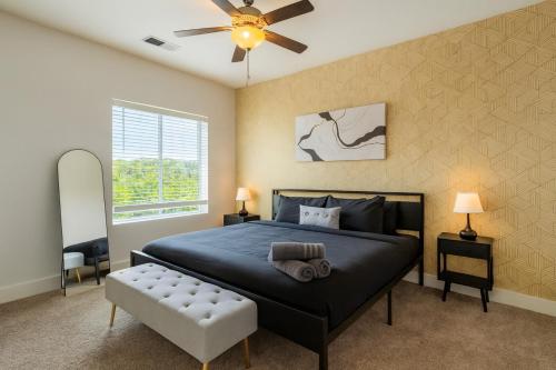 a bedroom with a bed and a ceiling fan at Luxury 2BR Condo Steps from UAB Campus 4th in Homewood