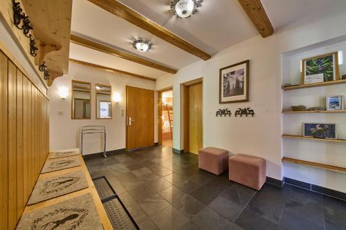 a hallway with a table and two stools at Apartments Enzian in Rauris