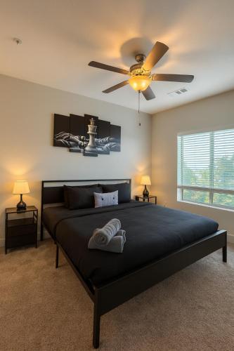 a bedroom with a bed with a ceiling fan at Across from UAB Spacious 2BR Retreat 3a in Birmingham