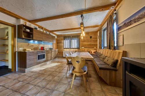 a kitchen with a long table and a couch at Apartments Enzian in Rauris
