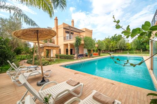 a villa with a swimming pool and a house at Villa with Private Garden & Pool Ourika, Atlas Mountains in Sidi Bouzguia