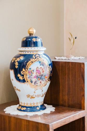 a blue and white vase sitting on a wooden table at Villa with Private Garden & Pool Ourika, Atlas Mountains in Sidi Bouzguia