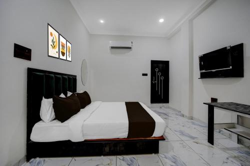 a bedroom with a large bed and a television at Hotel O Choice Inn II in Rao