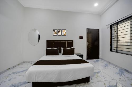 a bedroom with a large bed and a window at Hotel O Choice Inn II in Rao