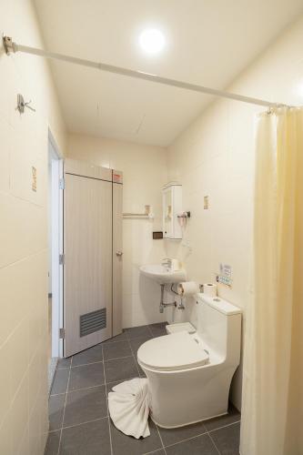 a bathroom with a toilet and a sink at Ratchadamnoen Residence in Bangkok