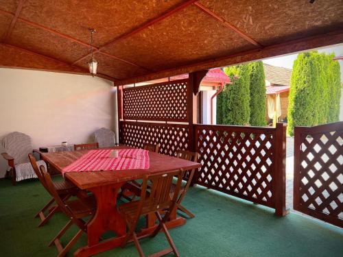 a wooden table and chairs on a wooden deck at B&B House 
