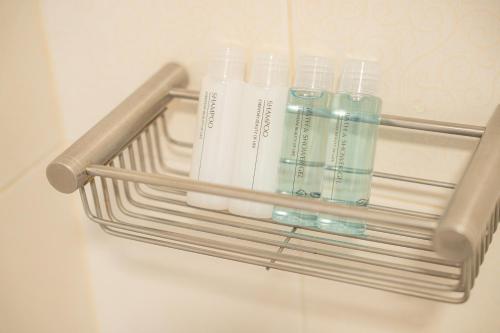 a rack with three bottles ofodorizers in a refrigerator at Ratchadamnoen Residence in Bangkok