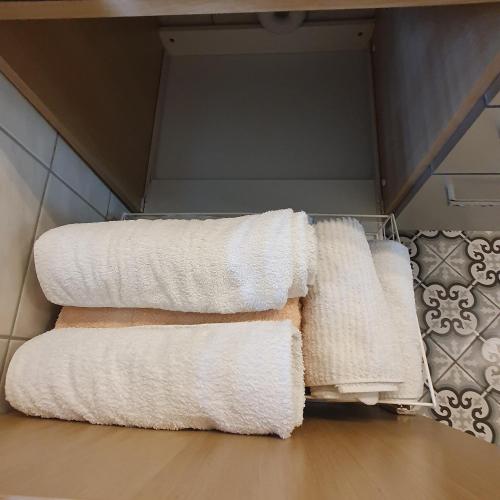 a pile of towels on a towel rack in a bathroom at Traditional Swiss-Flat in Interlaken