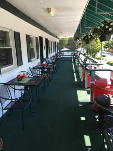 a row of tables and chairs on a patio at Crosswinds Motel in Old Orchard Beach