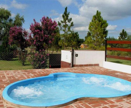 a large blue pool sitting on a brick patio at Cabañas El Paso in Villa del Dique