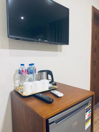 a table with a tray with cups and water bottles at Florya pyramids hotel in Cairo