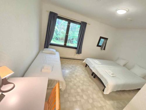 Ένα ή περισσότερα κρεβάτια σε δωμάτιο στο Nordic Inn