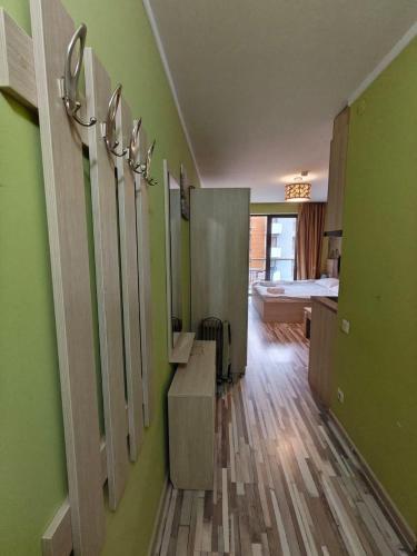 a bathroom with green walls and mirrors on the wall at Orbi Palace Delux A in Bakuriani