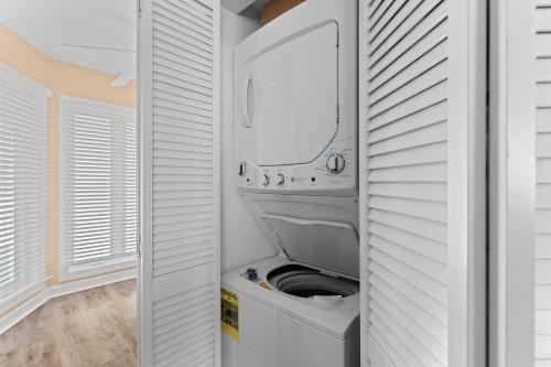 a laundry room with a washer and dryer at Port O' Call B201 - Direct Oceanfront Views in Isle of Palms