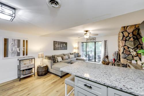 a living room with a couch and a table at Sevierville Condo with Balcony and Pool Access! in Sevierville