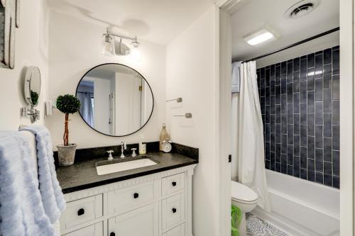 a bathroom with a sink and a mirror at Sevierville Condo with Balcony and Pool Access! in Sevierville