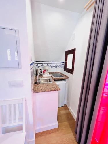 a small kitchen with a sink and a counter at El Beaterio Apartments in Tarifa