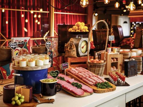 a buffet with sausage and other food on a table at ibis Styles London Southwark - near Borough Market in London