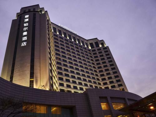 a tall building with a sign on the side of it at Pullman Dongguan Changan in Dongguan