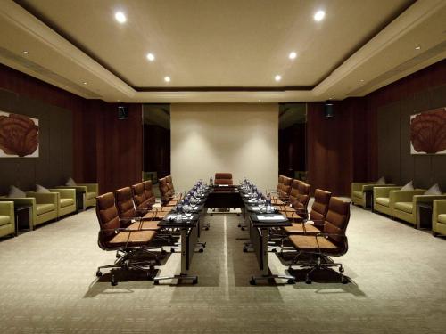 a long table and chairs in a large room at Pullman Dongguan Changan in Dongguan
