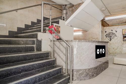 a set of stairs in a building with a sign at Hotel O LS BANQUET & ROOMS in New Delhi