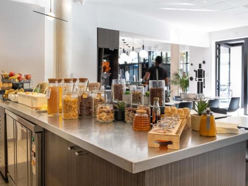 a buffet of food on a counter in a restaurant at ibis Styles Toulouse Cite Espace in Toulouse