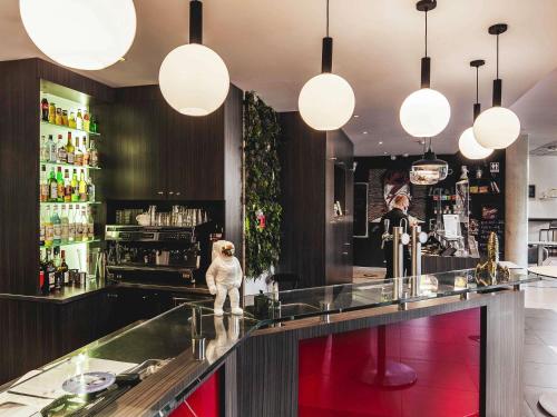 a bar with a monkey standing at the counter at ibis Styles Toulouse Cite Espace in Toulouse