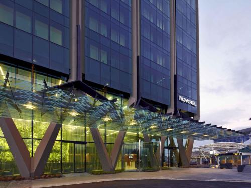 a building with a sign on the side of it at Novotel Auckland Airport in Auckland