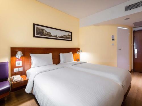 a large white bed in a hotel room at ibis New Delhi Aerocity - An Accor Brand in New Delhi