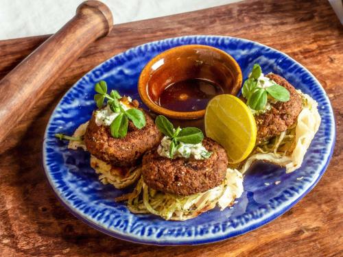 a blue plate of food with meatballs and spaghetti at ibis New Delhi Aerocity - An Accor Brand in New Delhi