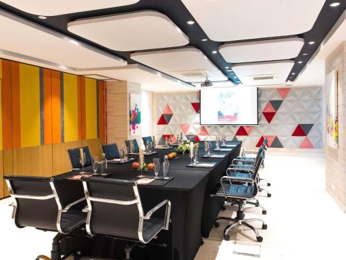 a conference room with a long table and chairs at ibis New Delhi Aerocity - An Accor Brand in New Delhi