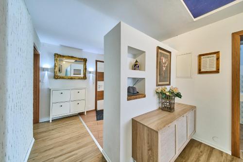 a living room with a mirror and a dresser at Apartments Enzian in Rauris