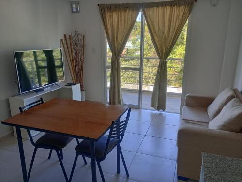 a living room with a table and a couch at Colon Sun in Colón