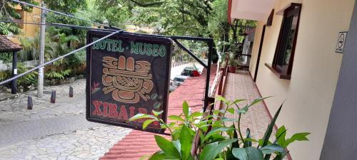 a sign for a restaurant on the side of a building at Hotel - Museo Xibalba in Palenque
