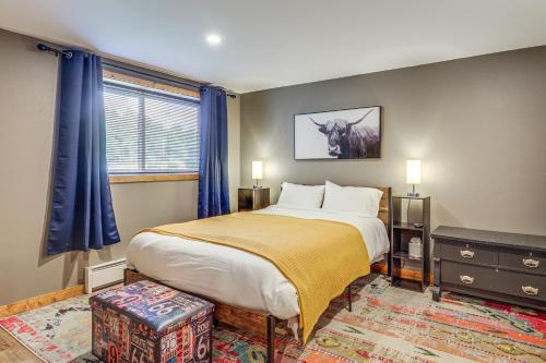 a bedroom with a large bed with blue curtains at Ski-InandSki-Out Condo in Upson - Walk to Lake in Upson