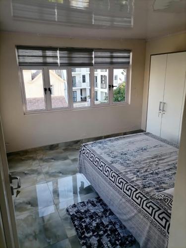 a bedroom with a bed and a window at Villa Tulip in Trou aux Biches
