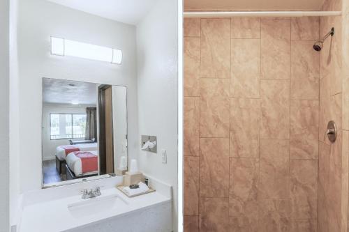 a bathroom with a sink and a shower at OYO Hotel Houston N Fm-1960 Champions TX in Houston