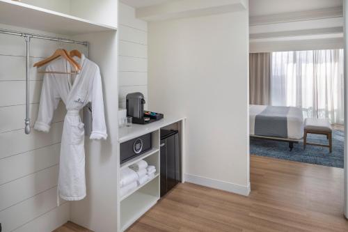 a hotel room with a robe and towels at Jupiter Beach Resort & Spa in Jupiter