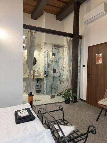 a room with a bed and a glass wall at Hotel Plzeňský Dvůr in Frýdek-Místek