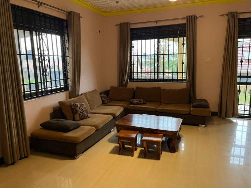 a living room with a couch and a coffee table at Paradise in najjera in Kampala