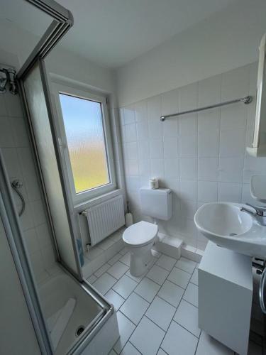 a bathroom with a toilet and a sink and a shower at Haus Nordseegruß 2 in Cuxhaven