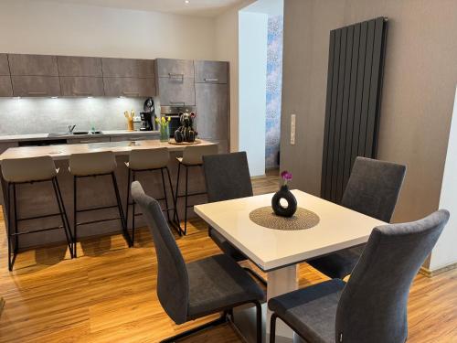 a kitchen with a table and chairs and a counter at Parkblick in Thale