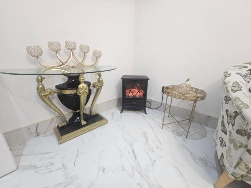 a living room with a table and a fireplace at Heaven in Sutton