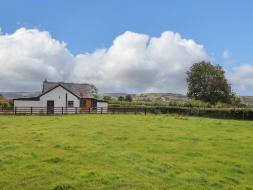 a white house in the middle of a field at Bethania in Oswestry