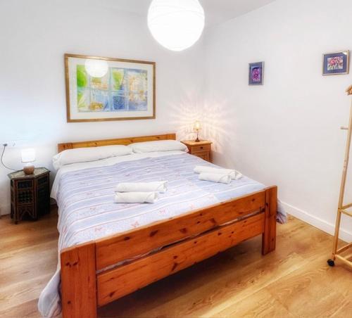 a bedroom with a large wooden bed in a room at El Beaterio Apartments in Tarifa