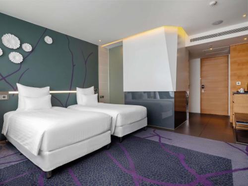 Postel nebo postele na pokoji v ubytování Pullman Saigon Centre
